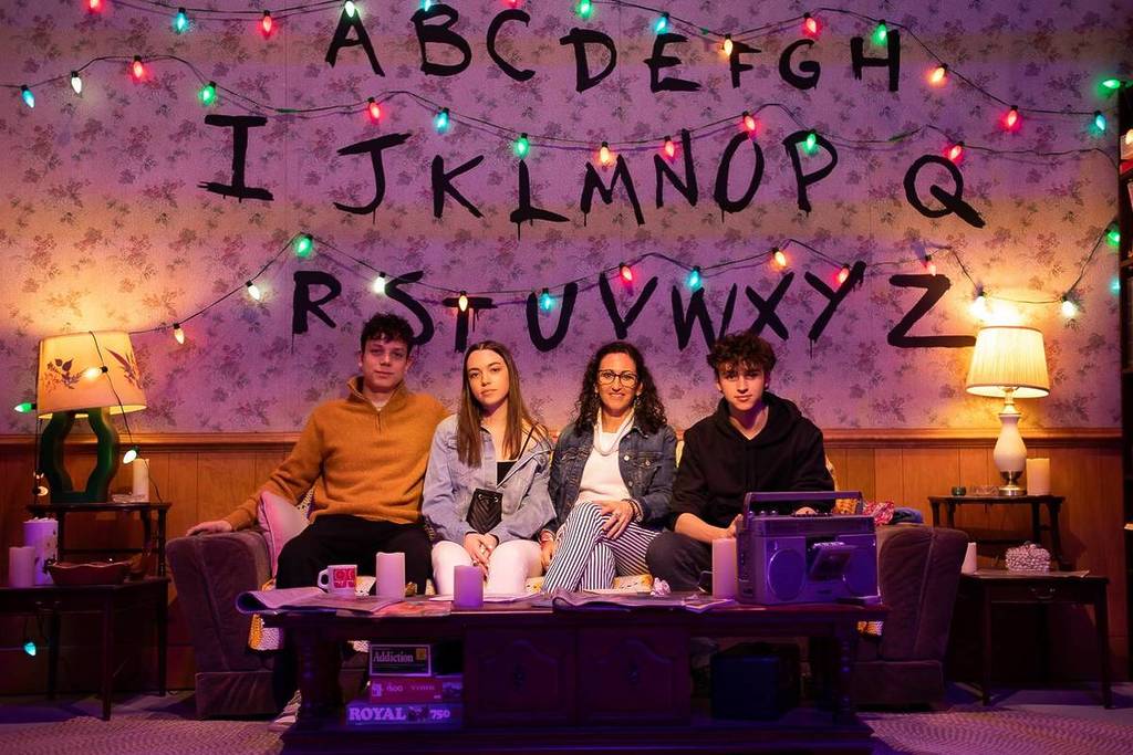 A group of guests sitting on the iconic Byers' living room couch