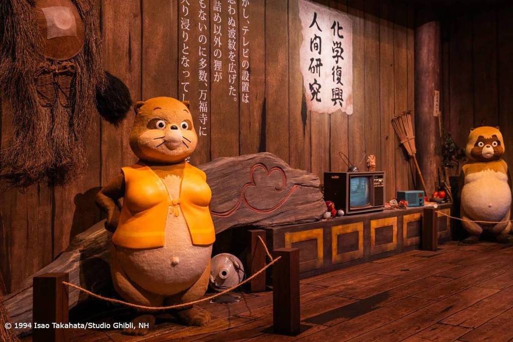 The World of Studio Ghibli's Pom Poko exhibition featuring detailed tanuki gathered in their home