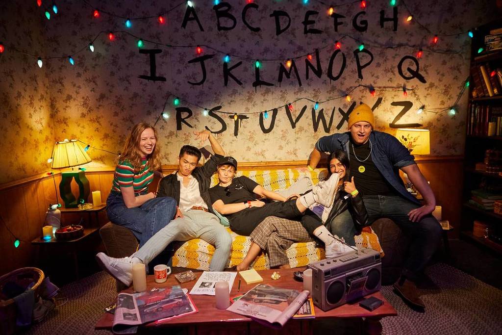 A group of guests excitedly gathered to post on the Byer's family couch