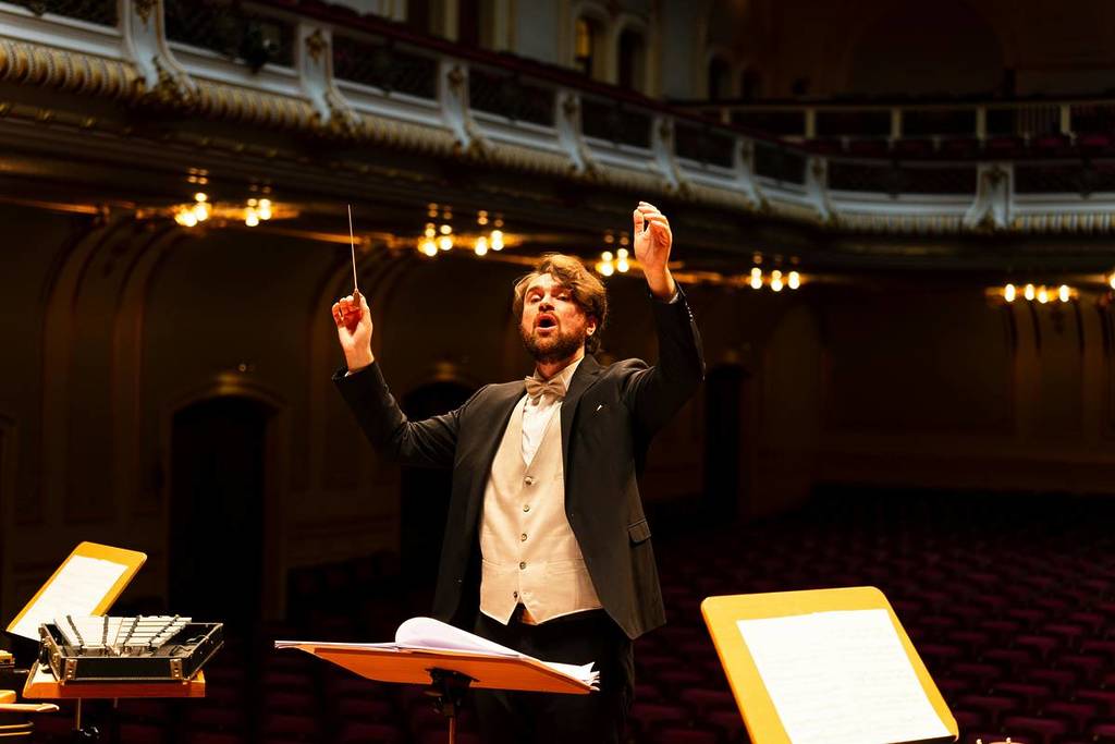 Close-up of a conductor conducting.