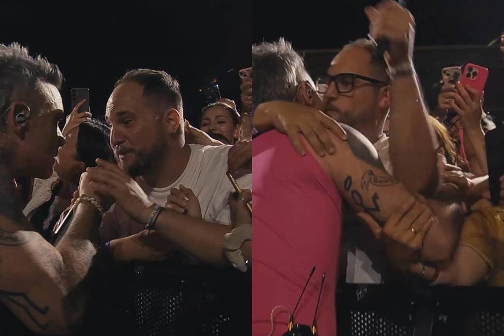 Robbie Williams fa cantare un fan al suo concerto a Barcellona: “È la mia canzone preferita, Rob”.