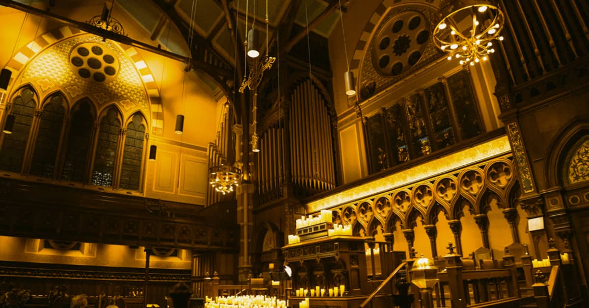 The nave of the Old South Church illuminated by thousands of candles