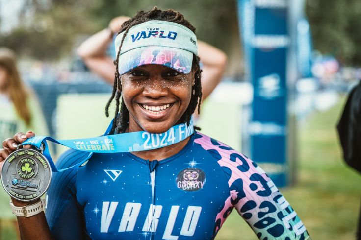woman wearing triathlon medal