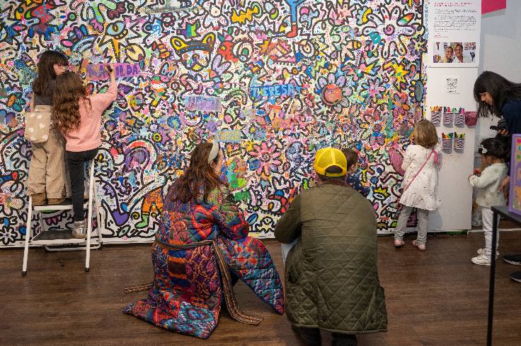two people looking at large colorful art