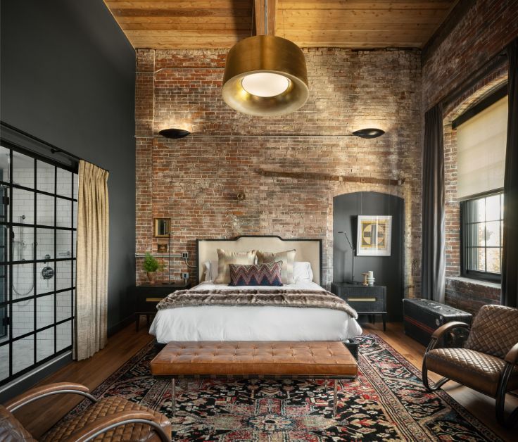 industrial hotel room with luxury linens and decor