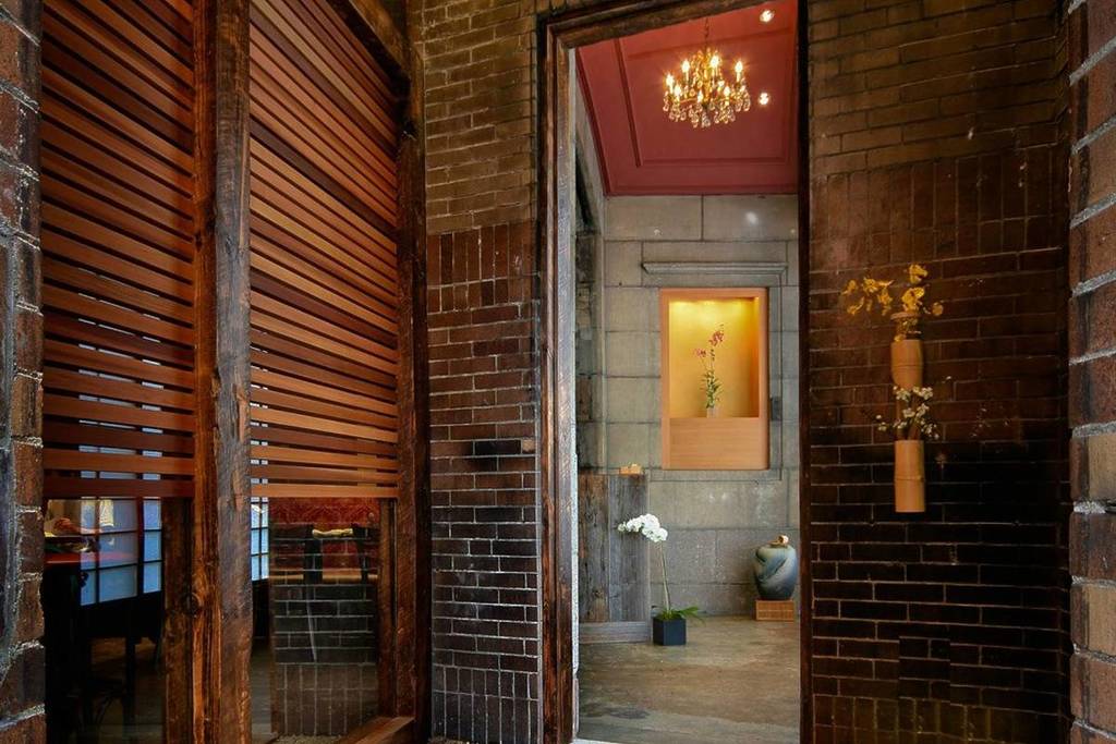 interior of restaurant with wood walls and dim chandelier