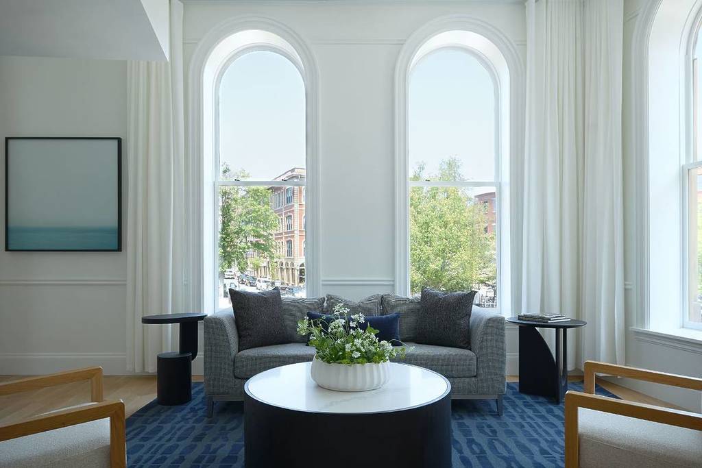 arched windows in living room with blue decor and views of portland