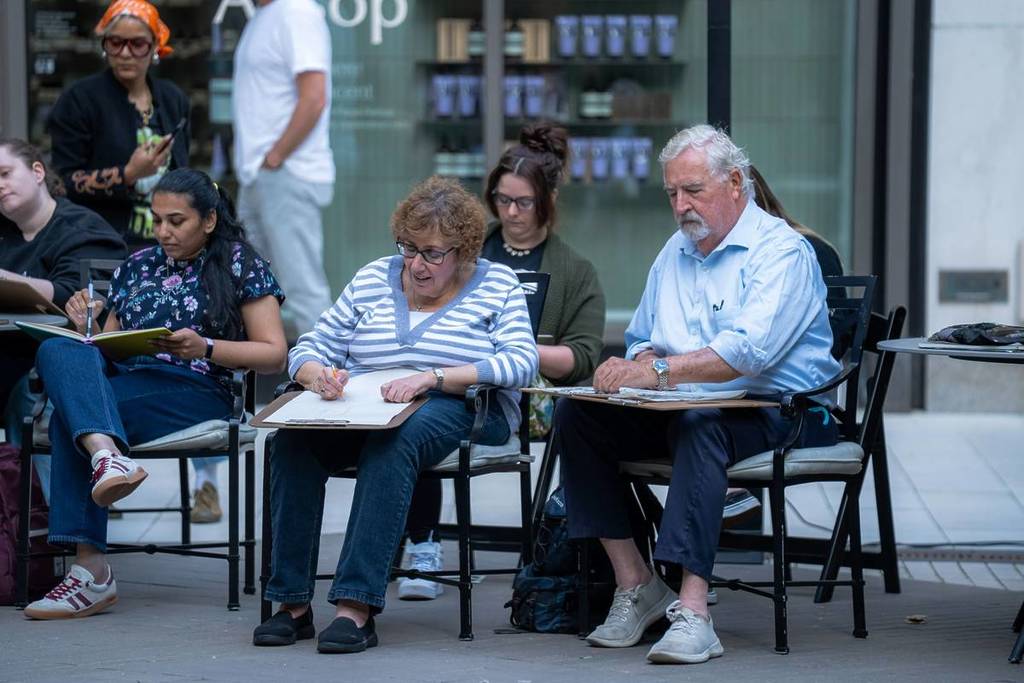 elderly couple drawing outside in boston