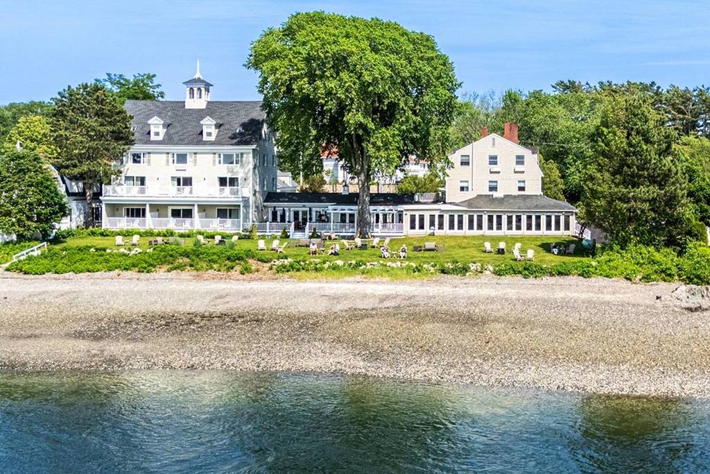 lawn and beach view of waterfront inn