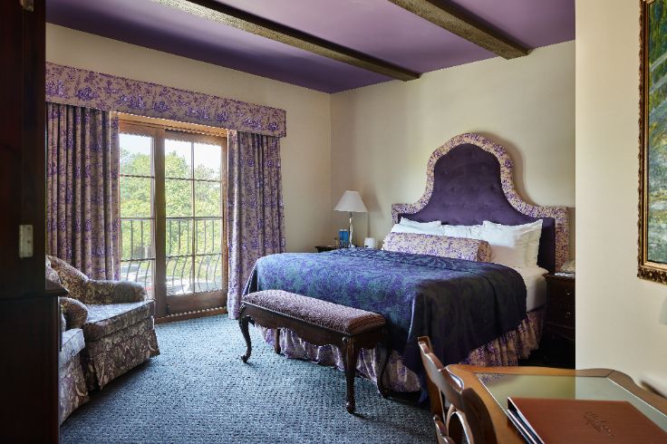 guest room with purple toile and french countryside aesthetic
