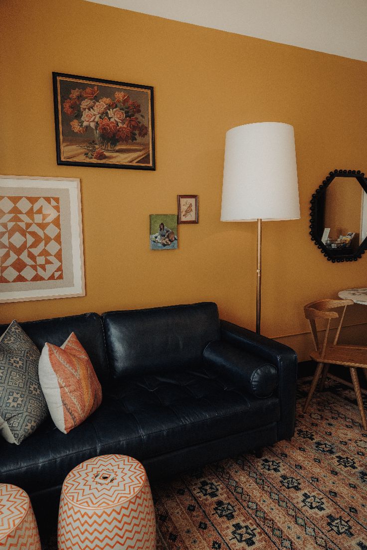interior yellow wall hotel room black couch