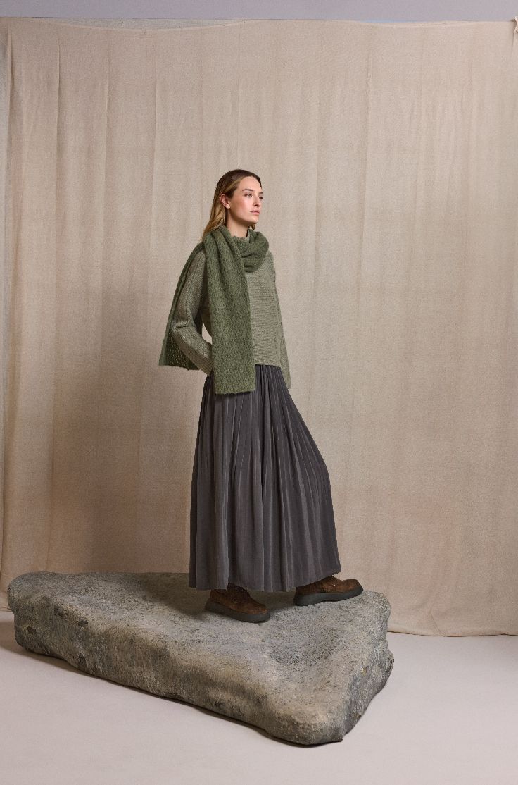 woman modeling sweater, scarf, and skirt