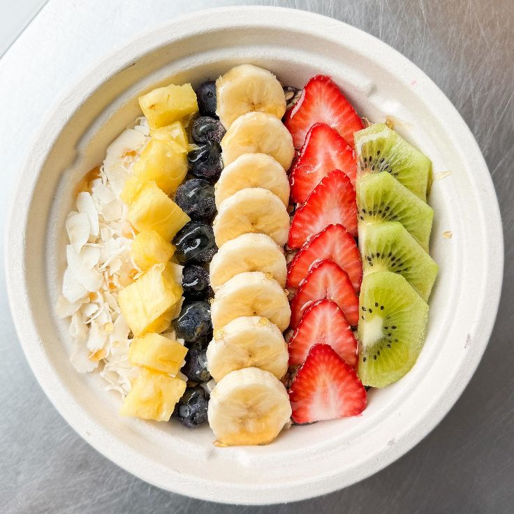 acai bowl with rows of fruit