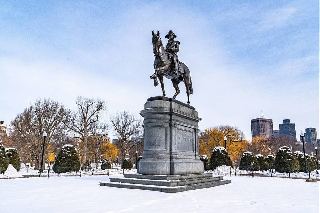 Boston, MA, USA - 11 February 2025 - Equestrian statue of George Washington at Boston Public Garden in winter against blue sky