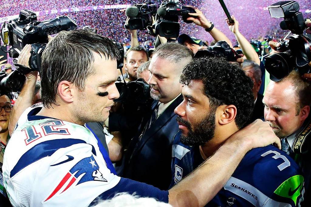 Tom Brady #12 of the New England Patriots is congratulated by Russell Wilson #3 of the Seattle Seahawks after Super Bowl XLIX at University of Phoenix Stadium on February 1, 2015 in Glendale, Arizona. The Patriots defeated the Seahawks 28-24.