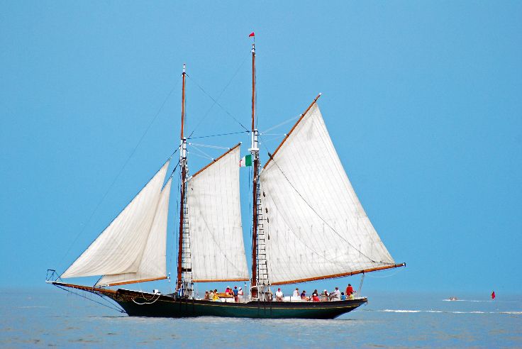 Gloucester MA, USA July 1 People enjoy a journey at sea as a schooner raises its sails on a summer day off the coast of Gloucester Massachusetts