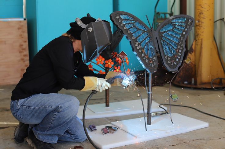 woman sculptor creating stained glass art