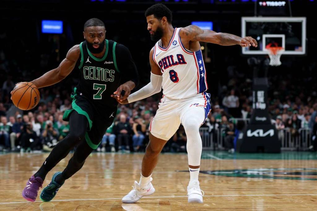 Paul George #8 of the Philadelphia 76ers defends Jaylen Brown #7 of the Boston Celtics during the second half of Game Five of the First Round of the NBA Eastern Conference Playoff at TD Garden on April 28, 2026 in Boston, Massachusetts