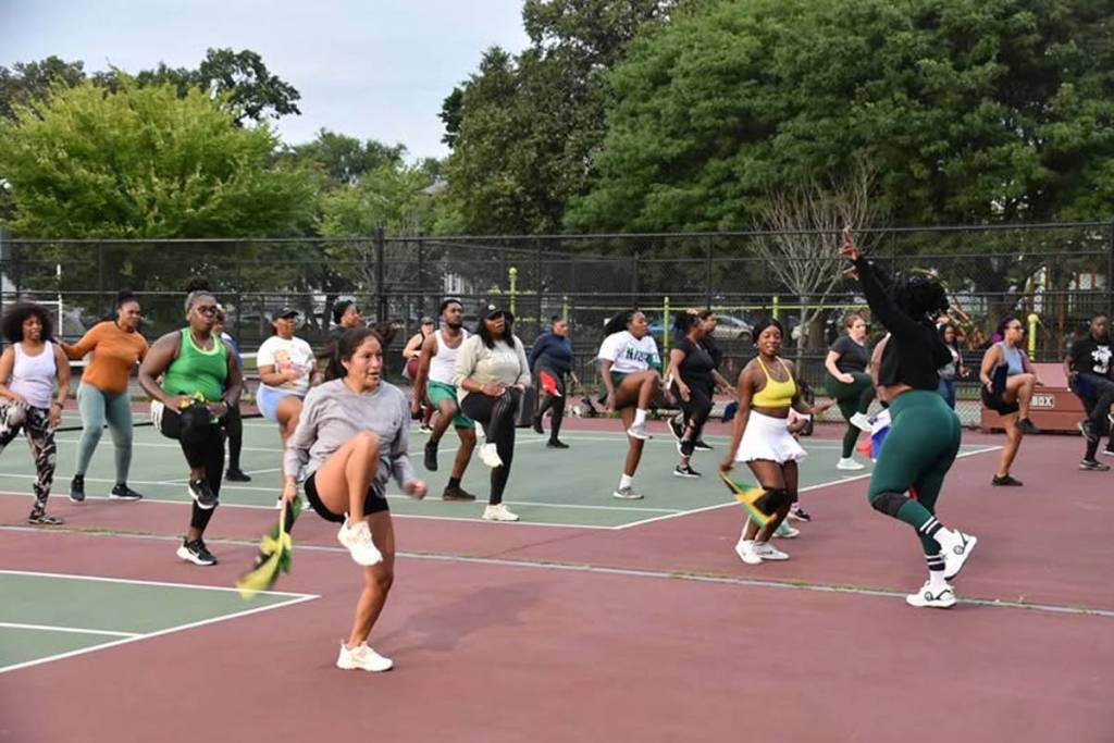 people exercising on a tennis court in boston