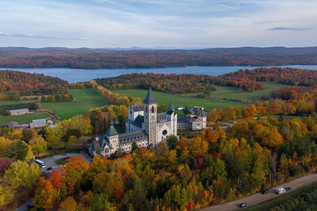 Autumn fall view from the drone at Abbey de Saint-Benoit-du-Lac next to Magog, Memphermagog lake, Quebec Canada