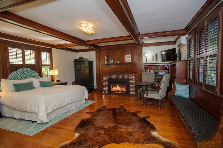 luxury room at inn with fireplace and wood beams