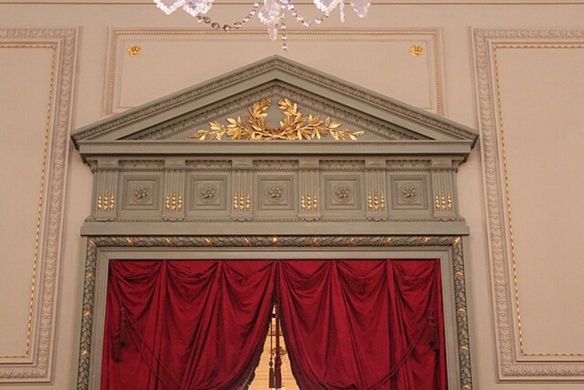 Photo de l'intérieur du Concert Noble à Bruxelles, zoom sur la porte avec des moulures dorées