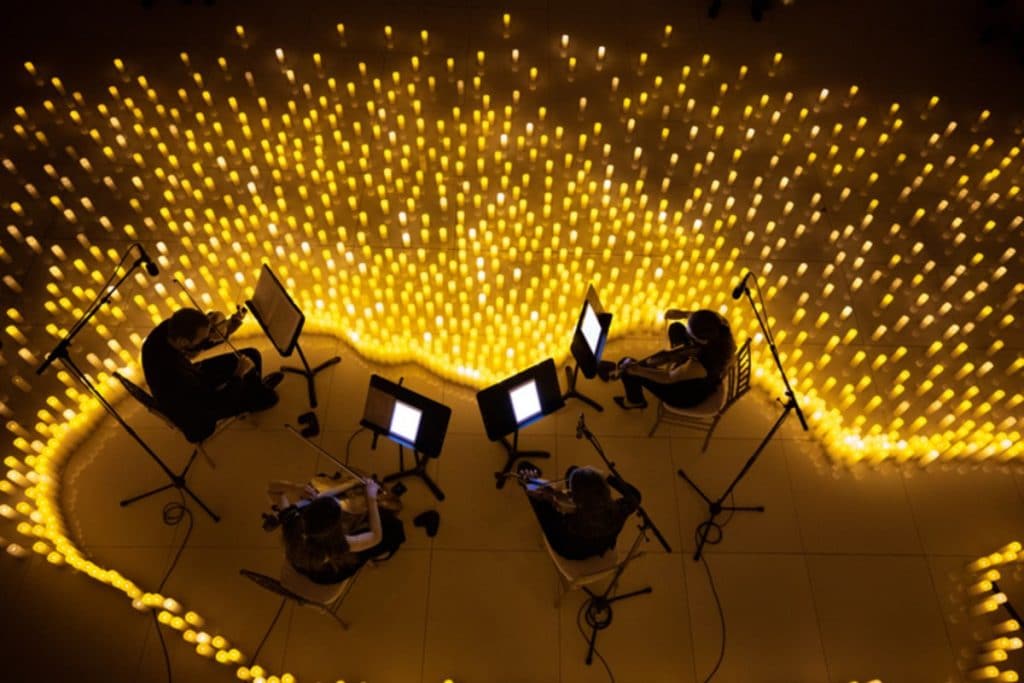 Musicians surrounded by candles at a Candlelight concert
