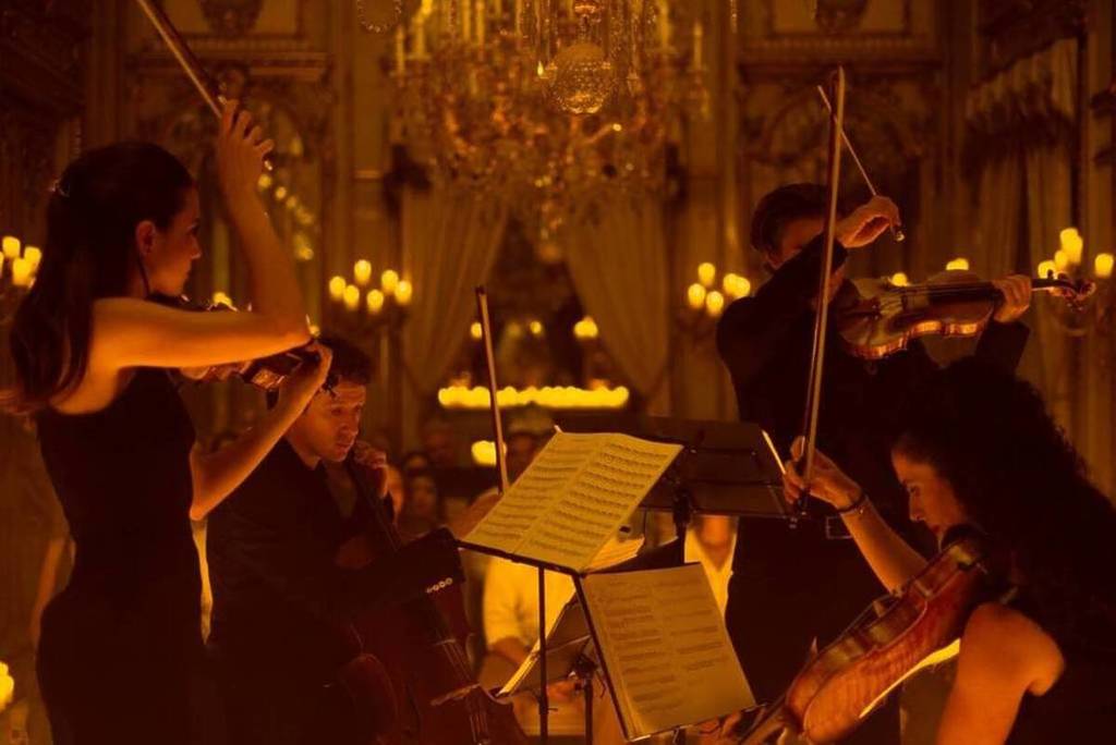 A string quartet plays on a stage during a Candlelight Halloween concert.