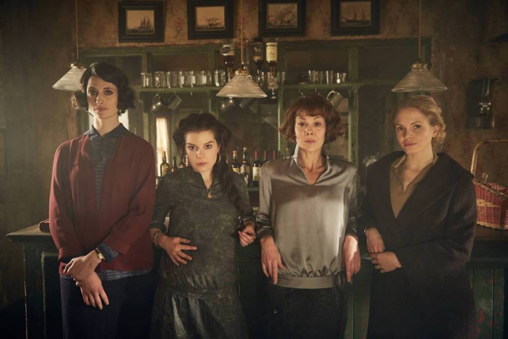 Cuatro mujeres de Peaky Blinders posan frente a la barra de un establecimiento de época
