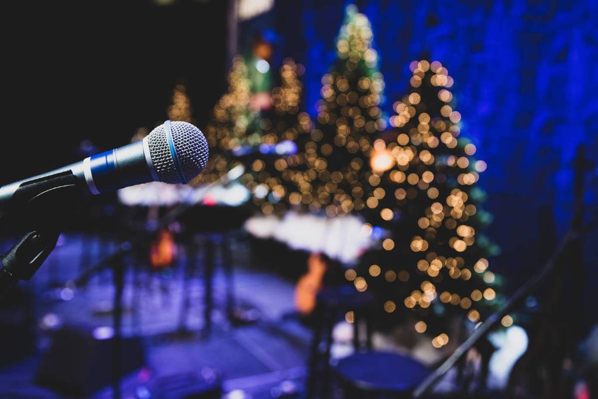 standing mic in front of Christmas trees