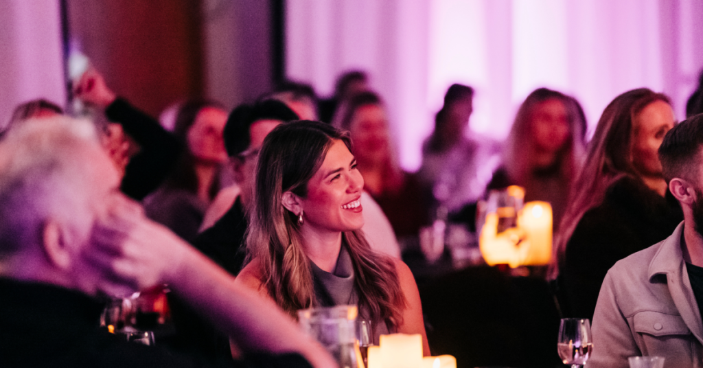 Audience members laughing during a comedy set