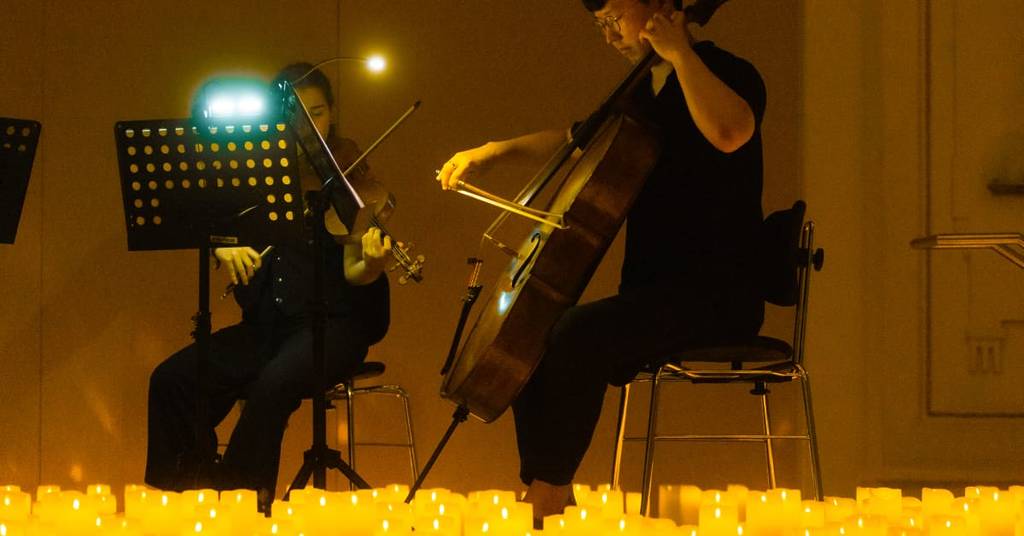 Classical musicians performing amid a sea of candles at a Candlelight concert