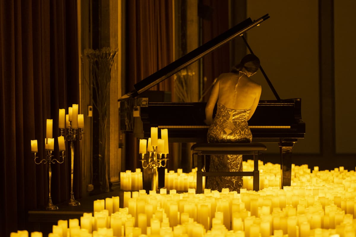 a pianist performing by candlelight