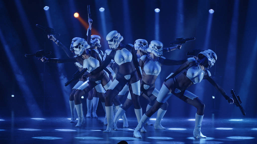 a group of stormtroopers perform a choreographed dance with fake guns at The Empire Strips Back show