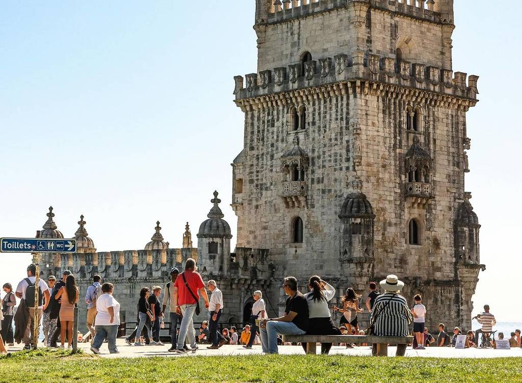 people visiting the Belém Tower on the weekend in Lisbon