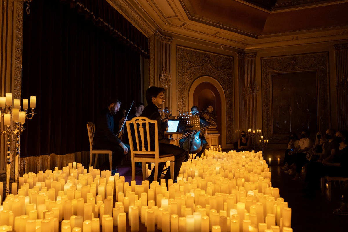 quarteto de cordas em palco repleto de velas nos concertos Candlelight