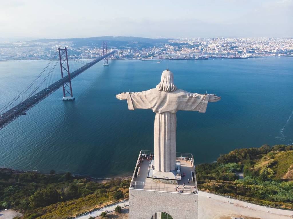 Cristo Rei illuminated in blue for OCD awareness