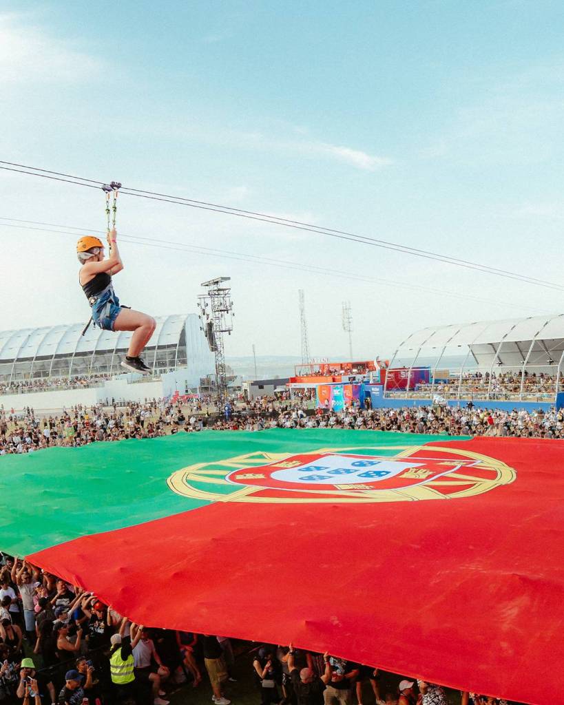 person in the slide under the Portuguese national flag at Rock in Rio Lisbon
