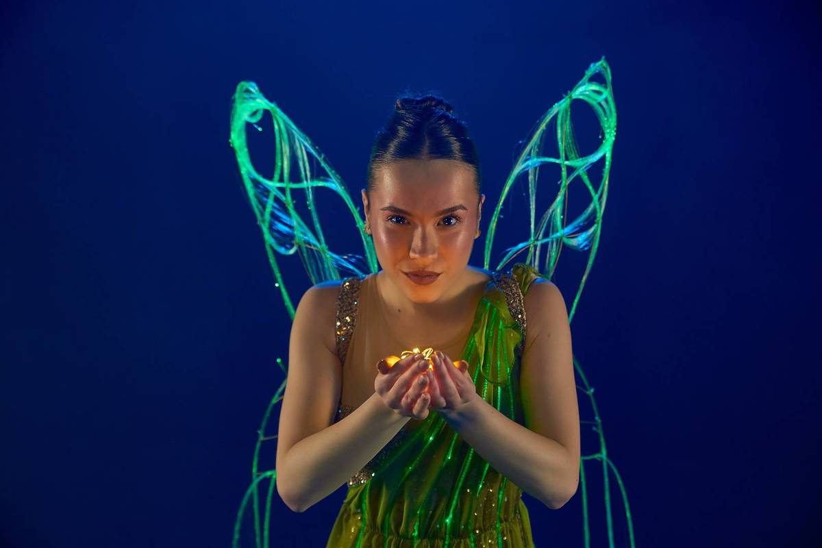 Mujer con alas de hada y traje de luces en Ballet of Lights