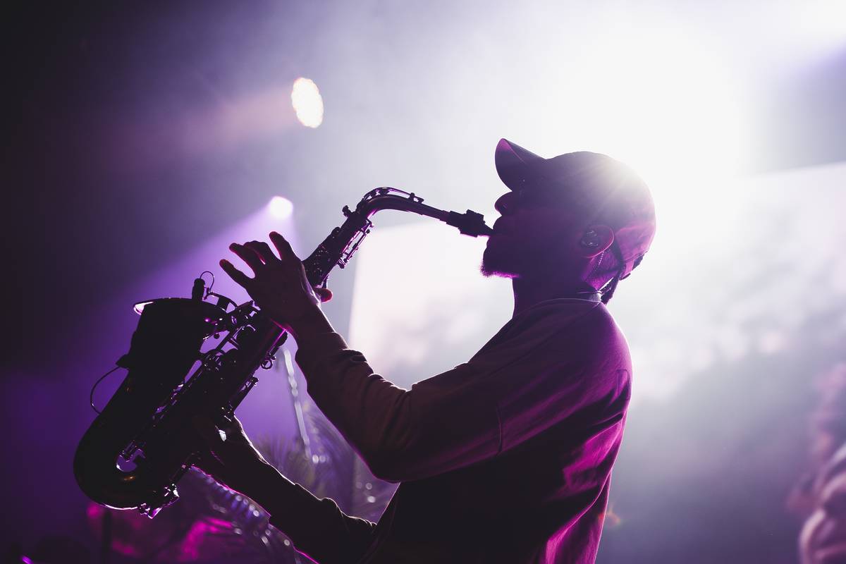 Saxofonista a contraluz tocando en un concierto