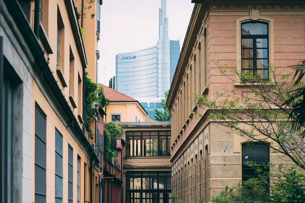 Photo of Milan showing balustrade-style houses with the Unicredit Tower in the background