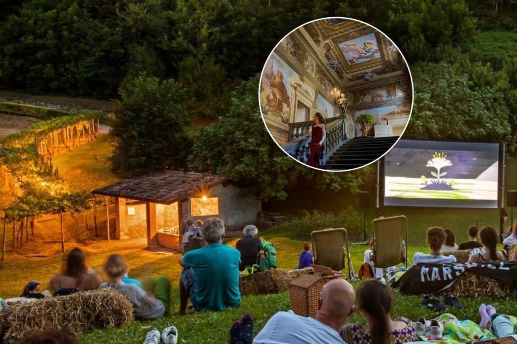 People watch a movie outdoors in the garden of Palazzo Moroni, a historic mansion adorned with frescoes