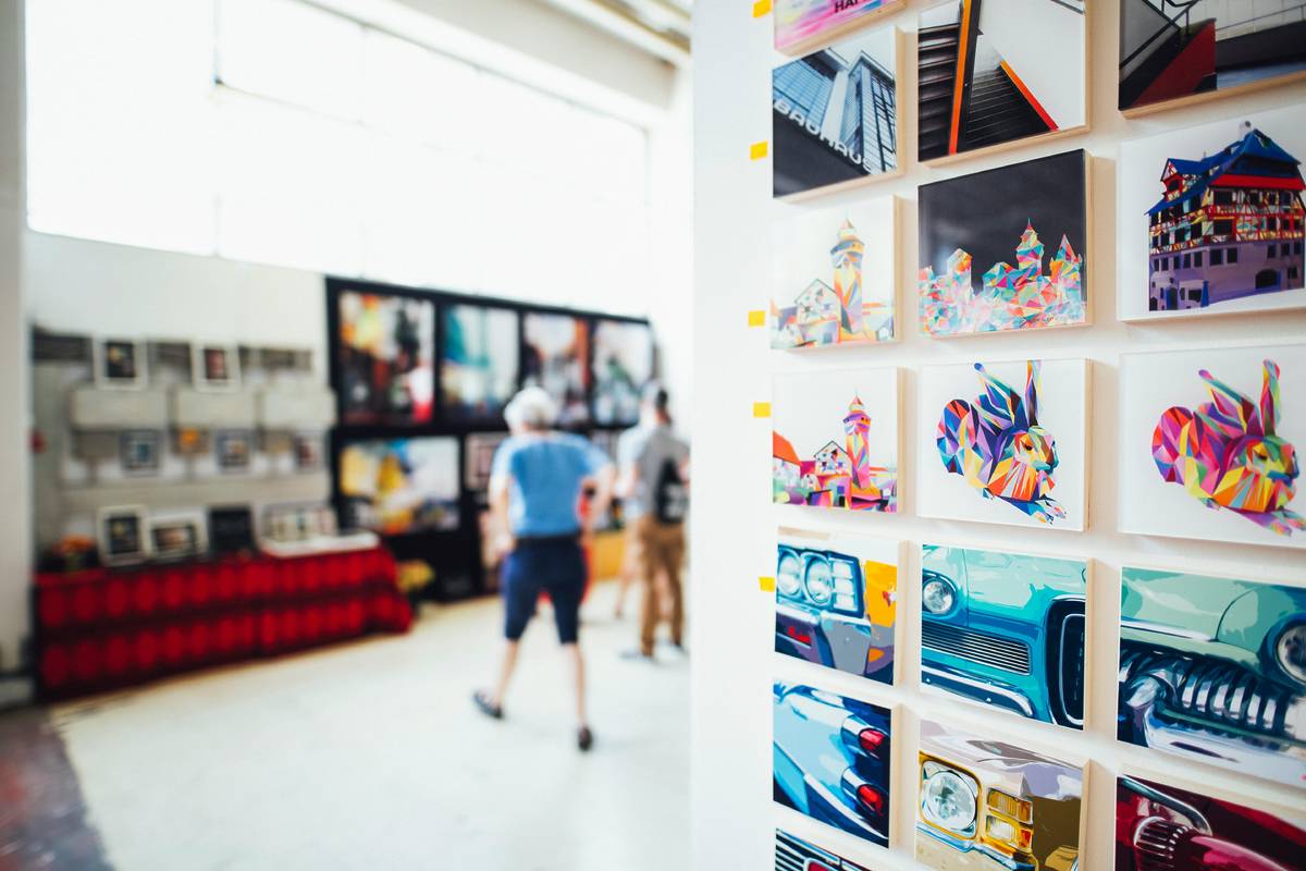 an art gallery or show with small paintings on the wall