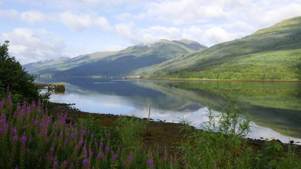 Tucked inside Loch Lomond, this peaceful Scottish village was named one of the UK’s most under-the-radar spots for scenic staycations