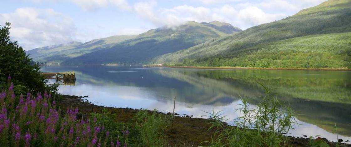 Tucked inside Loch Lomond, this peaceful Scottish village was named one of the UK’s most under-the-radar spots for scenic staycations