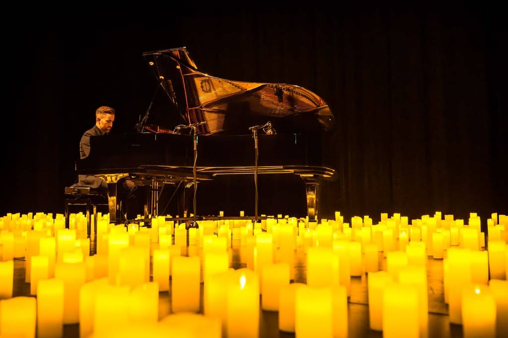 A pianist performing by candlelight