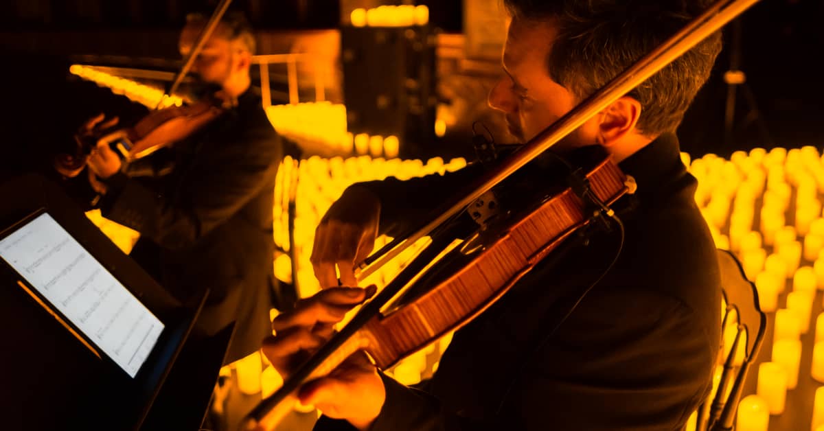 A musician playing the violin at a Candlelight concert