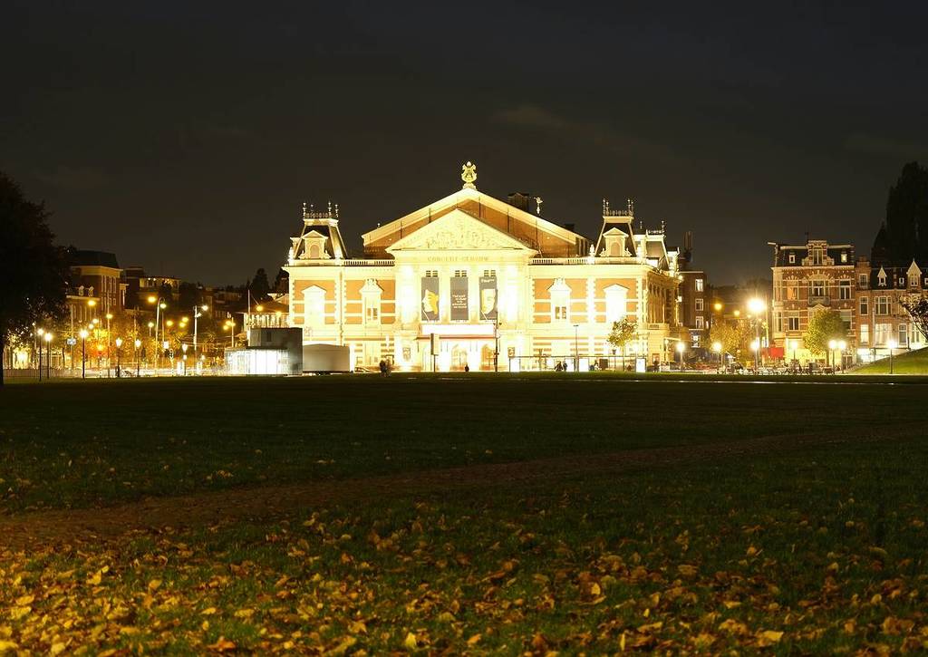 The decorative edifice of Concertgebouw illumintaed with golden light.