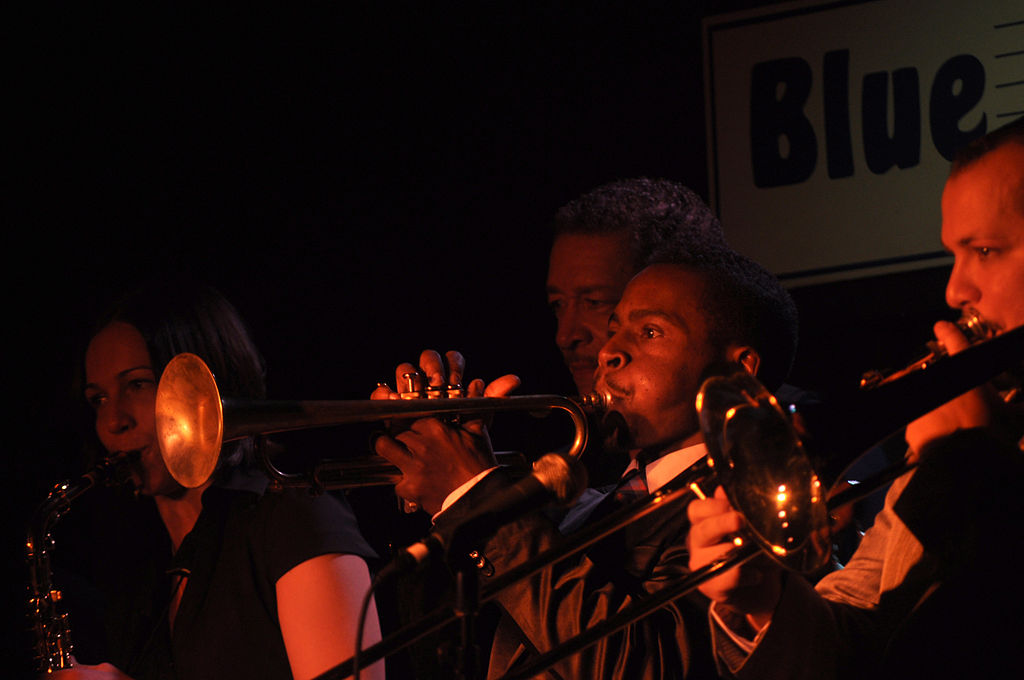 men play trumpets on stage