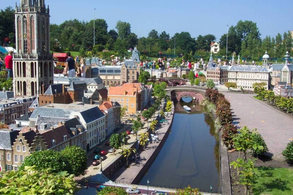 Panoramic photo of the miniature city of Madurodam, featuring Utrecht’s Dom Tower, canals, and visitors in the background.